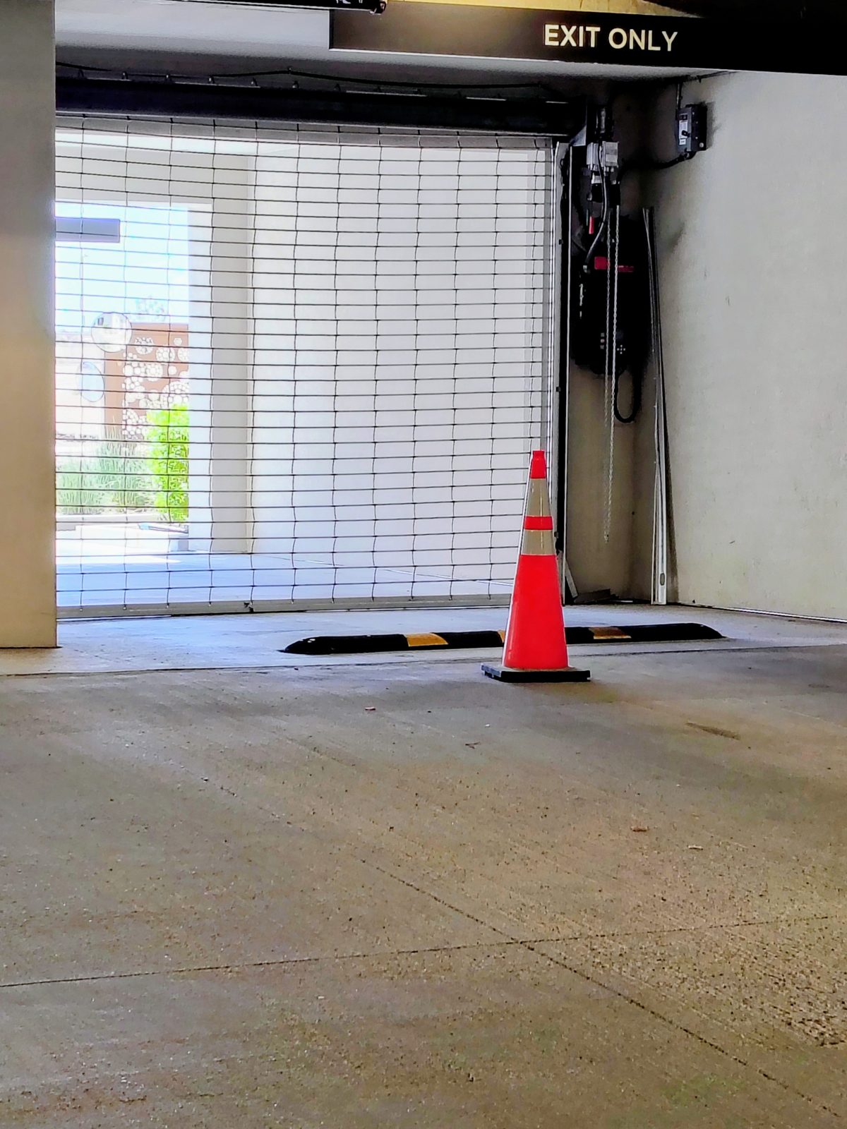 The garage gate out of service with a traffic cone in front of it, July 30, 2026
